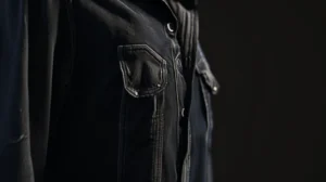 Jaqueta preta sobre fundo preto no outlet de roupas multimarcas.